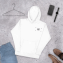 Sample of premium embroidered hoodie laying down with watch, phone, shoes around it