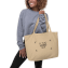 Una modella che porta al braccio una borsa personalizzata con logo